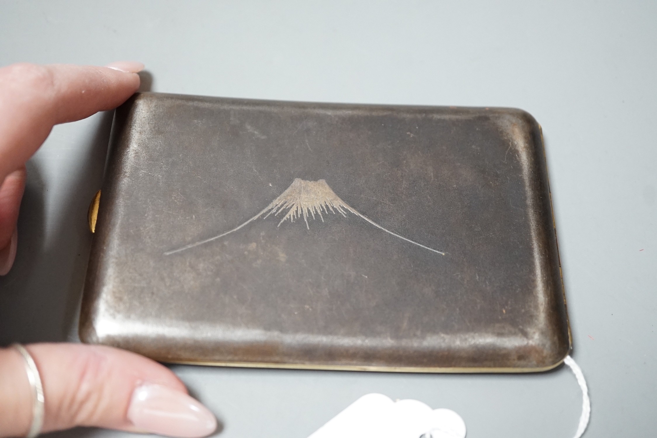 An early 20th century Japanese damascened iron cigarette case by Abe Shoten, 8x12cm